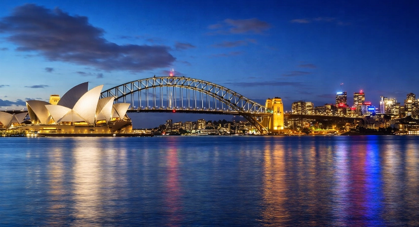 Vue nocturne de l’Opéra de Sydney et du Harbour Bridge, symboles emblématiques de l’Australie.